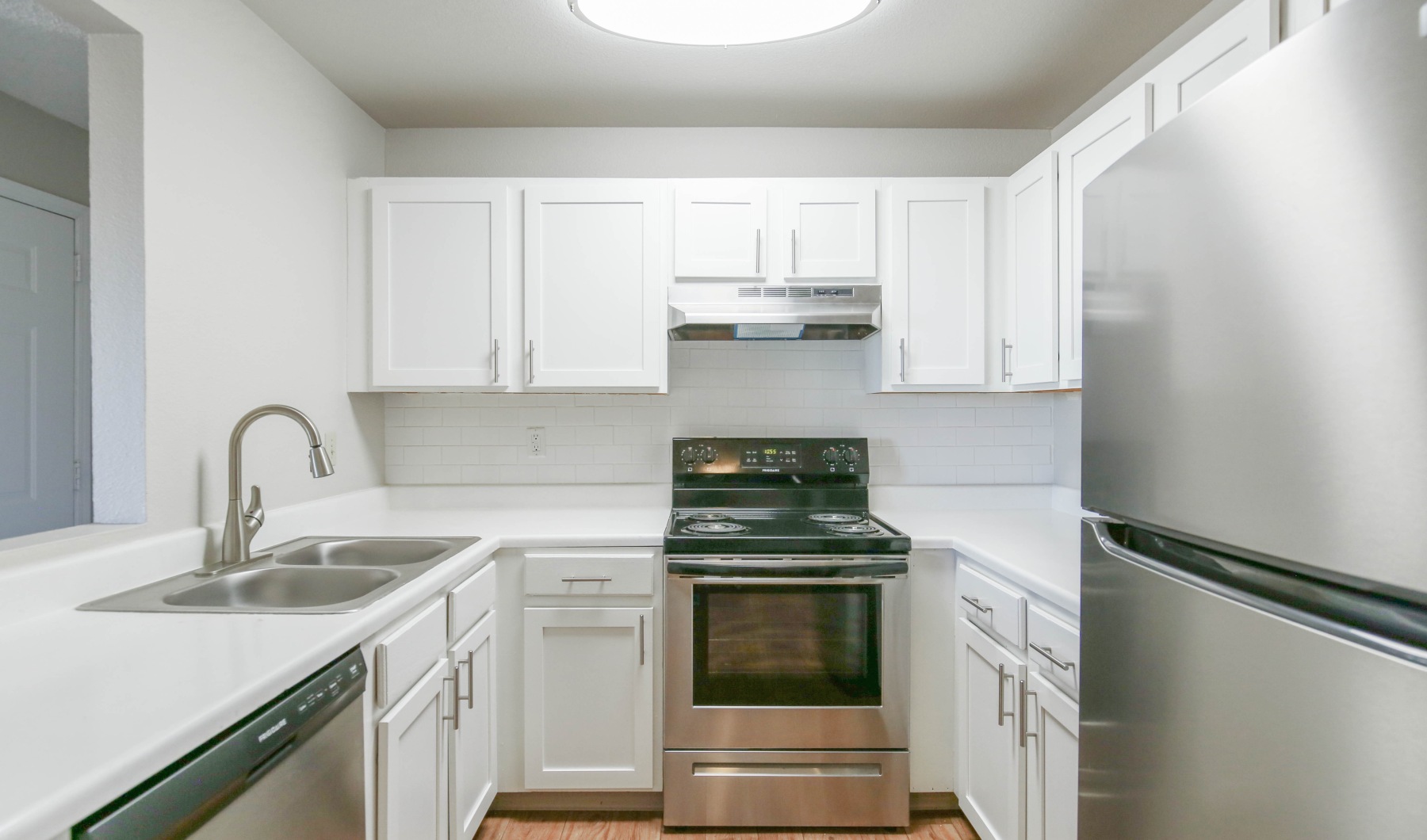 Whip up a meal in your upgraded kitchen Kitchen with white cabinets and stainless steel appliances